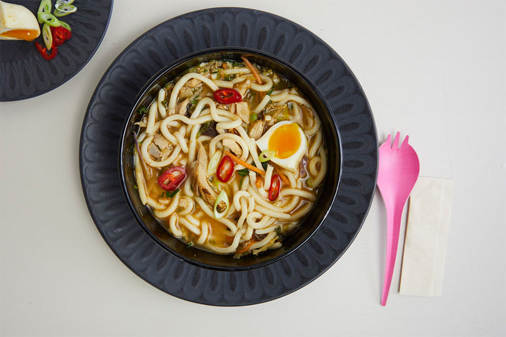 Soup bowl accompanied by an eco-friendly pink fork