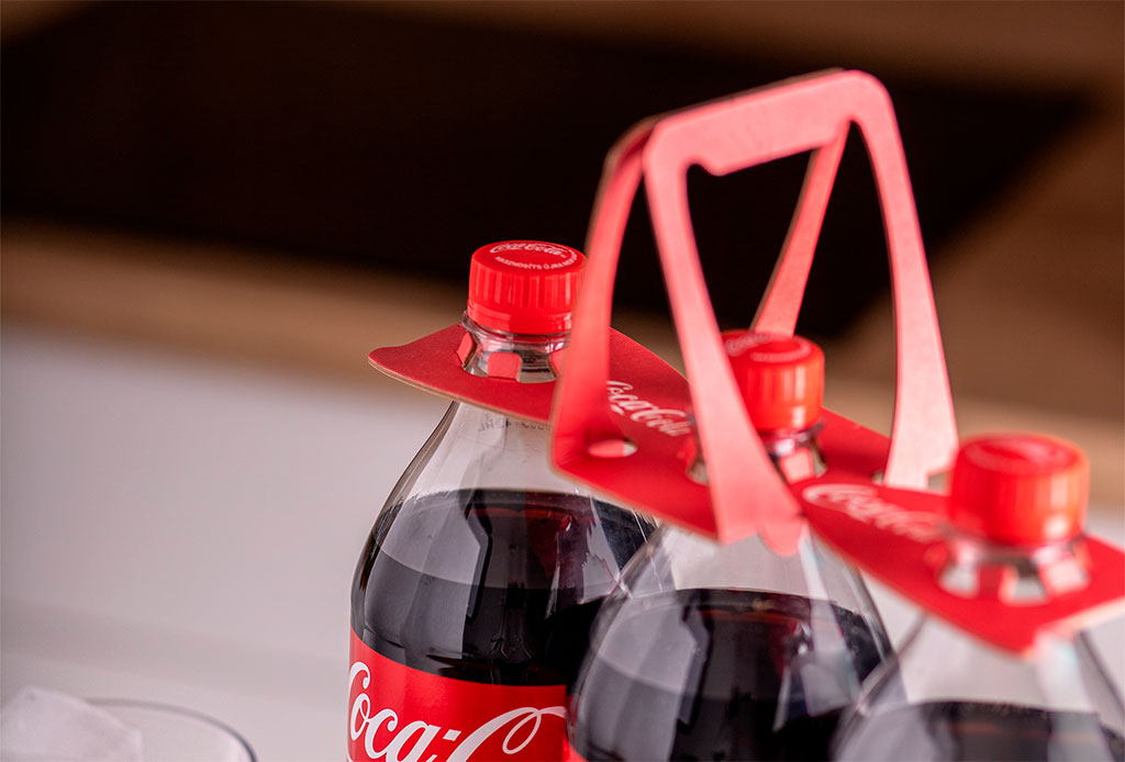 Eco-friendly and durable red paper bottle holder, cleverly designed to carry multiple bottles at once.