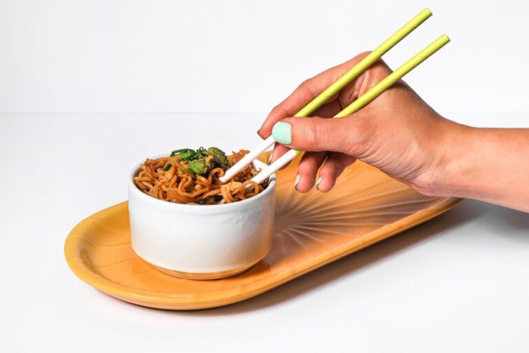 Noodles with pastel green chopsticks