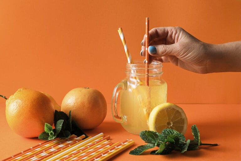 Cold drink served with eco-friendly paper straws as a sustainable alternative to plastic straws